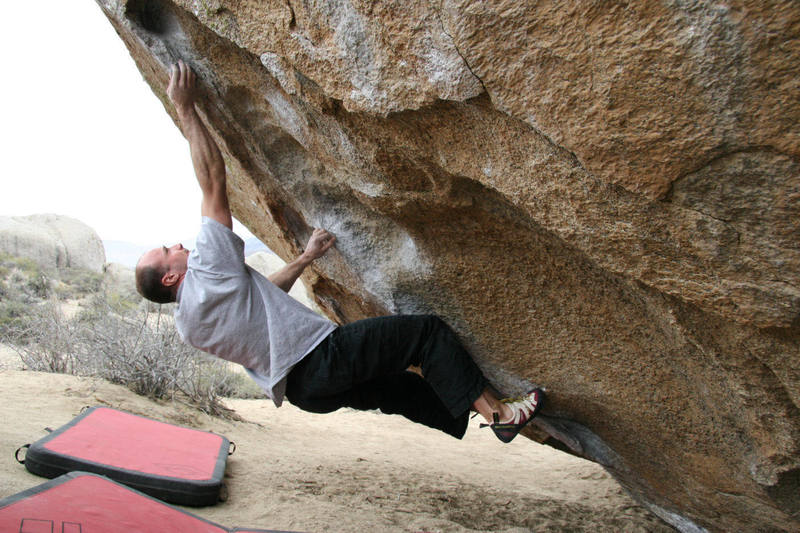 Mike sticks the long reach on Cave Route, V6.