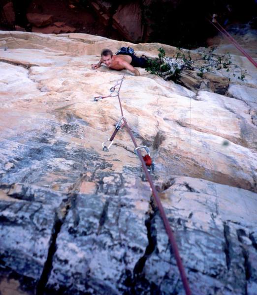 Mikael Orkomes follows 'Dianna Memory (5.11+)' at White Wall, in the Batu Caves area of K.L., Malaysia. Photo by Tony Bubb, 1995.