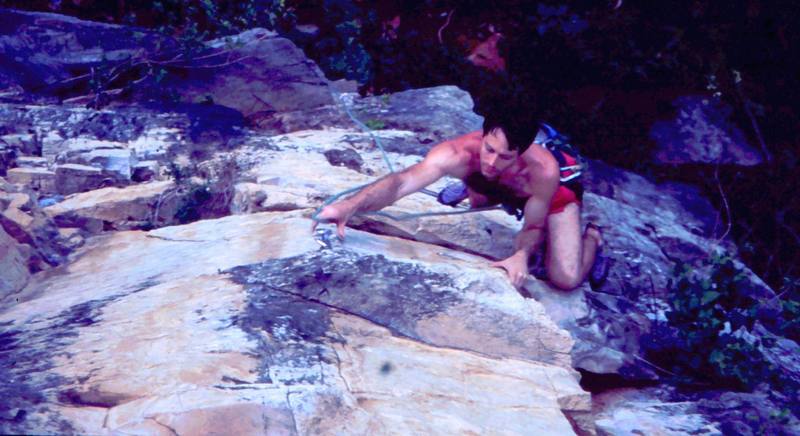 Tony Bubb goes for the clip on an unknown climb at White Wall, in the Batu Caves area of K.L. Malaysia. Photo by Kenny Low, 2005.