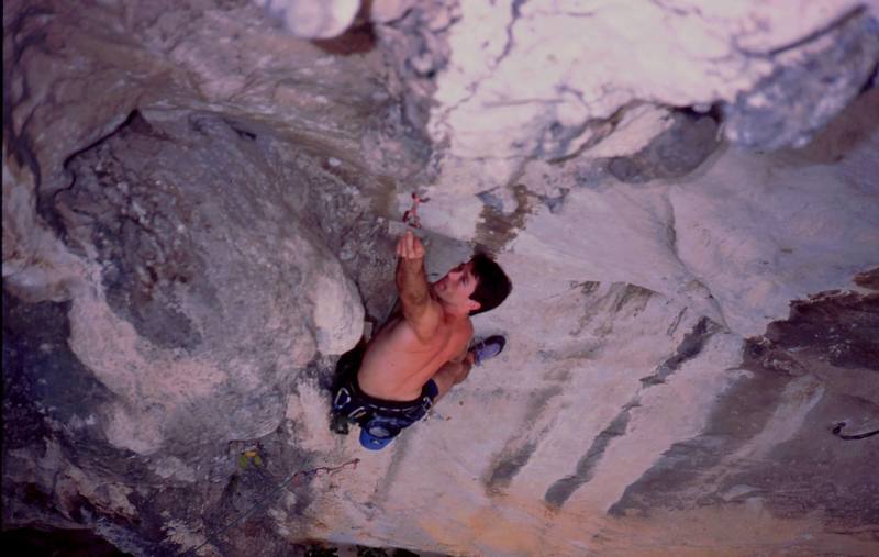 Tony, going for a long clip on 'For A Few Hangers More (5.10)' on the Nanyang Wall of the Batu Caves area in K.L., Malaysia. Photo by Kenny Low, 2005.