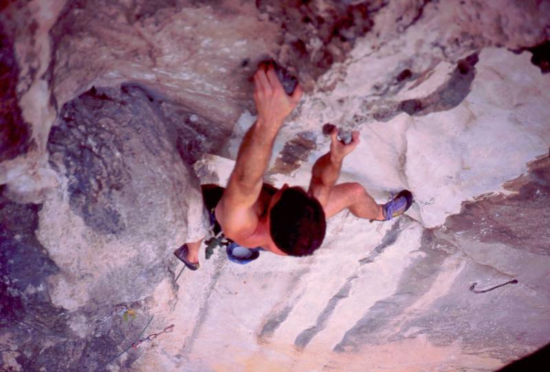 Tony getting to the final moves on 'For A Few Hangers More (5.10)' at the Nanyang Wall of the Batu Caves area in K.L. Malaysia. Photo by Kenny Low, 2005.