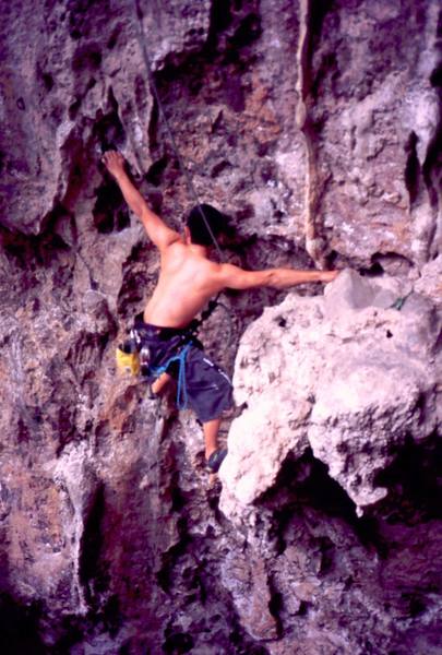 An unknown climber on the steep juggy start of 'Parang Buta (5.10)' at Nanyang Wall of the Batu Caves area in K.L. Malaysia. Photo by Tony Bubb 2005.