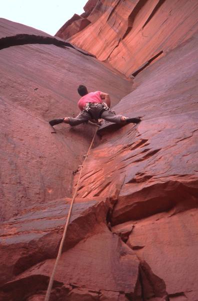 Tony Bubb starts up the thin crack and open book stemming of 'Virgin Voyage (5.10+)' at Fin Wall, in Indian Creek, UT. Photo by Joseffa Meir, 2/2006