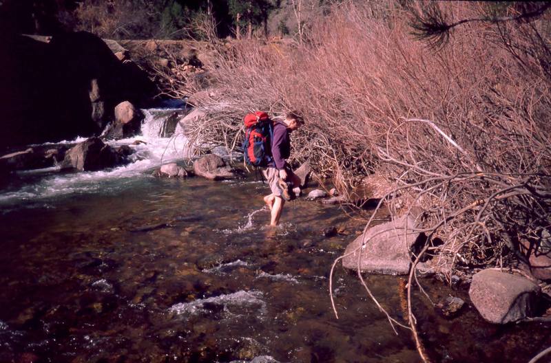The early spring and late fall approach to the West Ridge can be a plesant and mellow stream crossing. Peter Spindloe enjoys the feel of it in April, 2000. Photo by Tony Bubb.