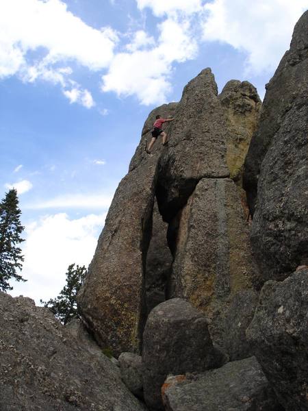 Burt Lindquist moving onto the summit block of Stonehenge while climbing "One Epic Leads to another".