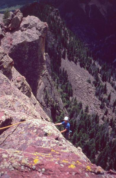 Ivan Rezucha tops out on Pole Vault, at the distant and peaceful Physical Crag, in Eldo. Photo by Tony Bubb, 2004.