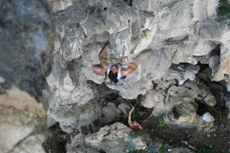 Tony Bubb enjoying the good "clipping holds" (hardey-har-har)of 'Circumcision (6b)' on Nanyang Wall at Batu Caves, in K.L. Malaysia. Photo by Kenny Low, 2006.