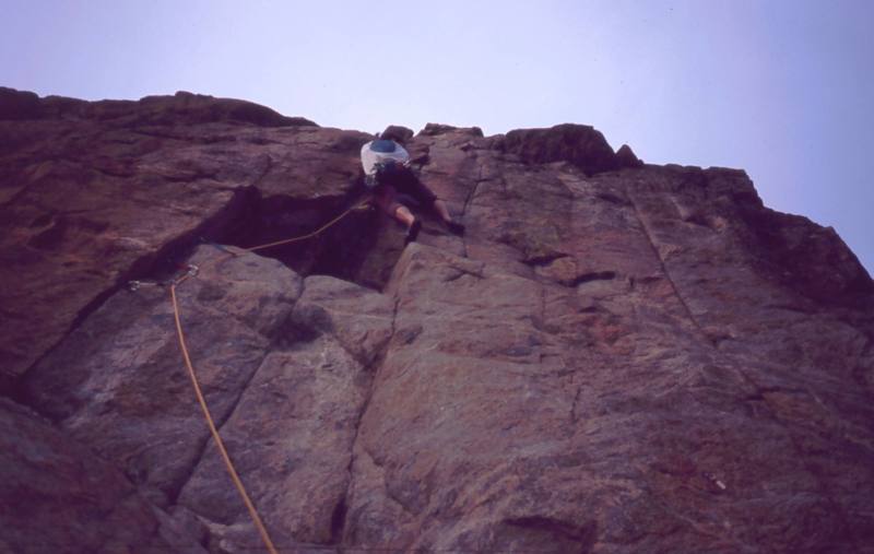 Tony Bubb tries to figure out the crux of 'Thumb Tack (5.11+)' at the Bihedral Rock in Boulder Canyon. The steep crux is protected by a micro-cam or a small nut. Photo by Alan Doak, 2004.