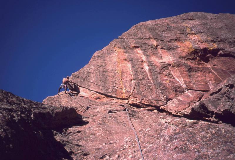 Tony Bubb negotiates the crux Overhang of the classic "Satan's Slab (5.8)" of Skunk Canyon, in the central Flatirons of Boulder. Photo by Peter Spindloe, 2003.
