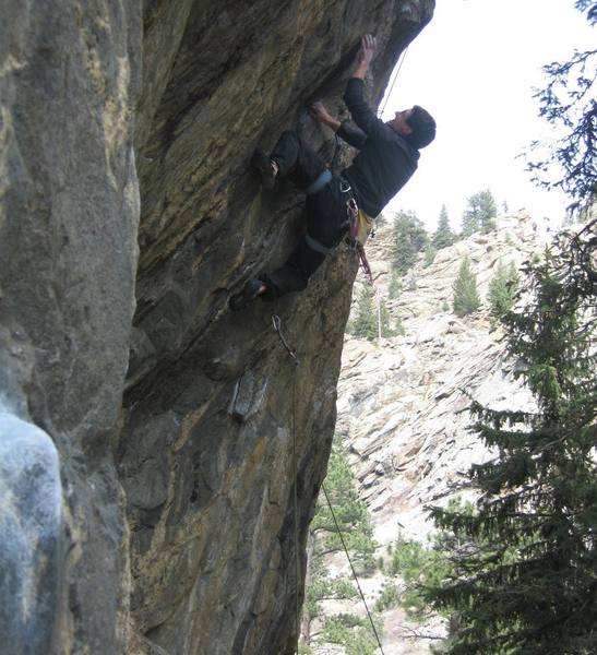 Zach Allen reaching for the crux 2-finger pocket.