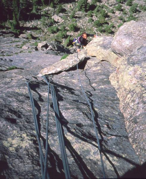 John Cioci follows the first pitch of 'Crystal Balls (5.10, X)' on the F.A. of the route. Photo by Tony Bubb, 2002.