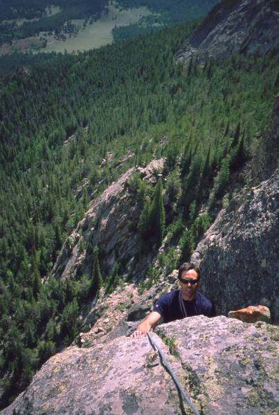 Tony Bubb tops out on the final pitch of 'Crystal Balls (5.10, X)' on the F.A. of the route. Photo by John Cioci, 2002.
