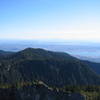 From the summit of Crown Mountain looking south towards Vancouver.  The Grouse Mountain resort is visible on a shoulder horizontally in-line with the Burrard Inlet.
