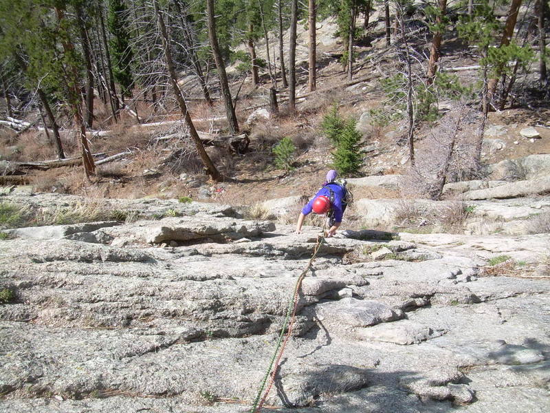 Upper bit of P1. Funky, looks like she's just stepping off the ground, but it's 80' below. Those are backpacks down below, to Deb's right in the photo.
