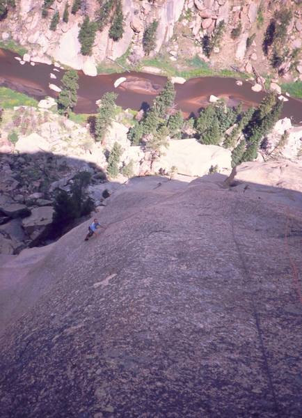 Josh Janes gets onto the main slab of Childhood's End on what we thought was going to be a nice day. Photo by Tony Bubb, 2004.