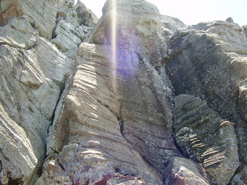 A view of the main part of the wall. 5.6 in the crack to 5.10 on the overhang