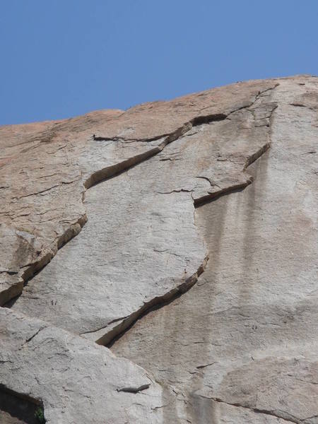 Starting at the anchor, move left and up the right-facing dihedral on the left side of the picture.  Above the crack the climb runs out on very easy slab to a bolted anchor.