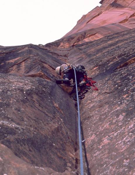 Tony Bubb leads on the upper pitches of Prodical Son (IV, C2) in Zion National Park. Photo by Mary Ann Dornfeld, 2004.