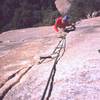 Ron Roach looking forward to some fine crack climbing on the upper half of the first pitch of 'Bee Line' on the Stonghold Dome. Photo by Tony Bubb, 12/2001.