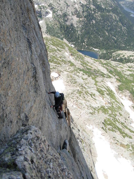 Clint following the traverse on pitch 8. The bolt is a still bit further out.