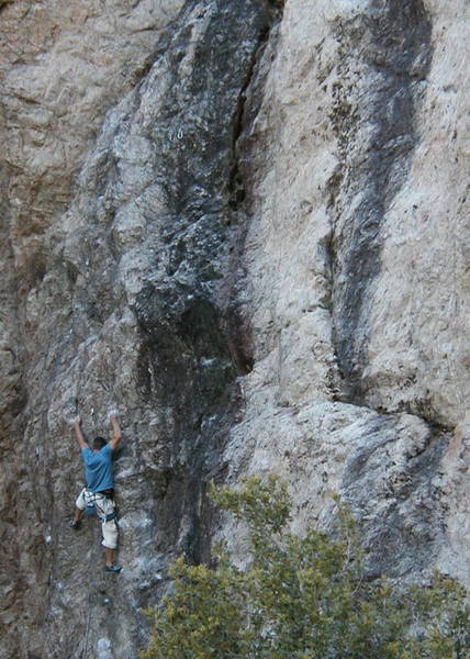 A climber nears the anchors on Industrial Disease (5.10c), Williamson Rock <br>