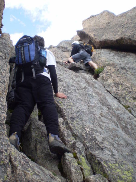 Some friends scambling to the summit through the 'staircase.' We accessed this pitch via the 'Loft' into the west side of the Notch.