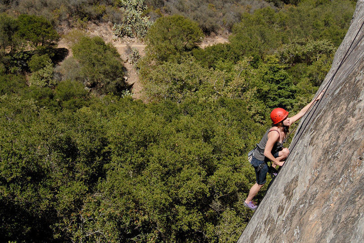 Marissa climbs through Fine Line's 2nd crux, delicate slabby moves past the routes first bolt.