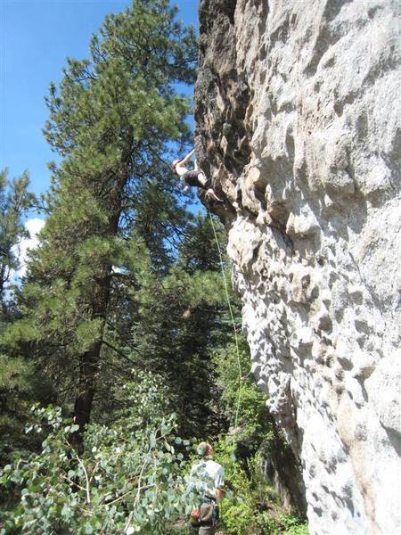 Blue sky in the background of a photo at Area 37? Holy sh...! Allison leading "Leprosy" on a nice summer morning at the crag.