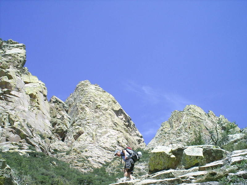 Scott Jones sweating out the descent hike after climbing the Middle Rabbit ear (directly behind him).