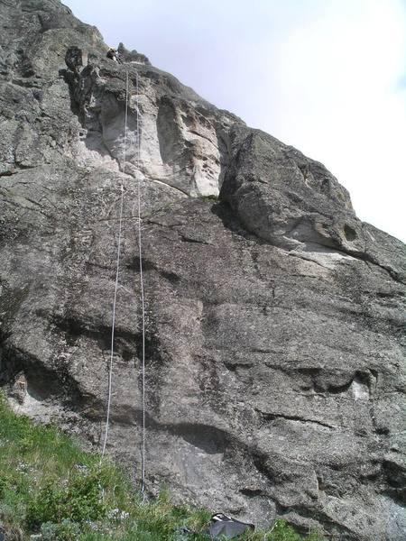 Getting ready to rap off the South Ridge. The climb starts from the grassy ledge, climbs to the block, and then follow the ridge to the sharp pinnacle (or to the top).