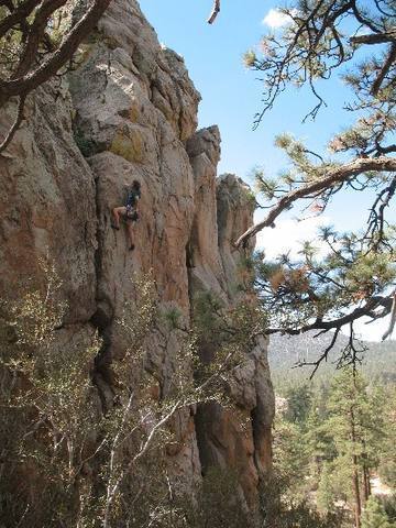 Phil at the crux of Bum Steer (5.10a), Holcomb Valley Pinnacles.