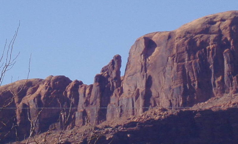 The Point of Moab taken from the visitor's center in Moab. Bolts for a highline are on the rim and then summit anchors on the tower.