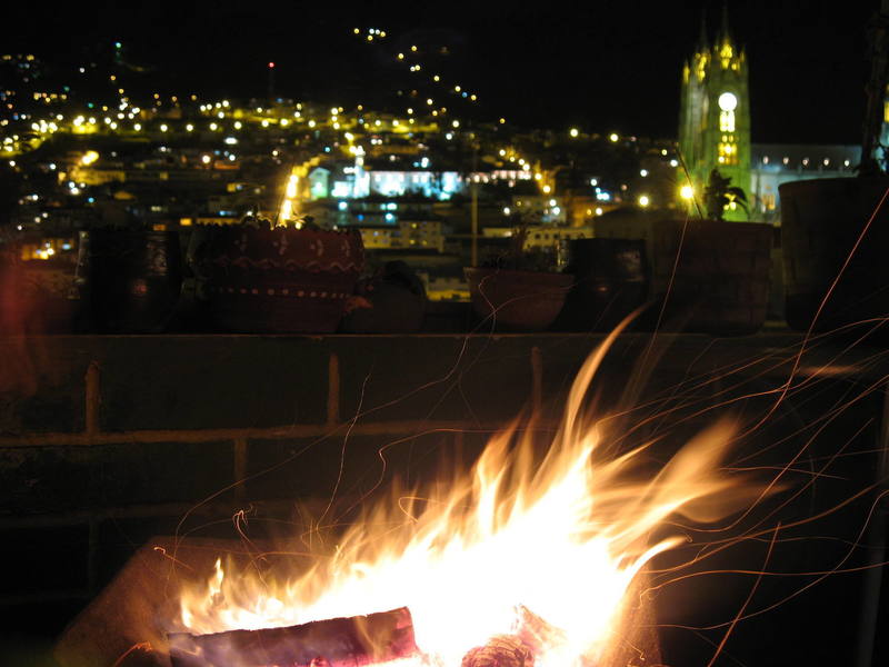 Wheelbarrow bonfire on the 5th floor terrace of the Secret Garden hostal, Old Town Quito, Ecuador.