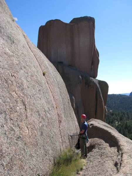The crack is visible to Derrill's left. It splits the face, and is easily visible from the ground. We replaced the rappel slings to the west on 9.22.07.