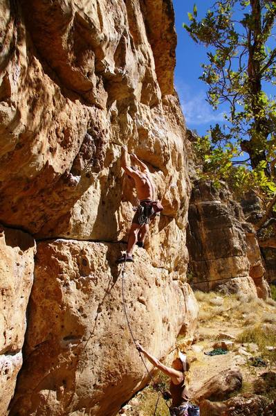 Erik Wolfe getting established on Carmel Coated Fun with Deidre belaying.