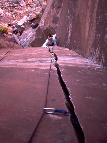 Joseffa Meir turning the steep upper moves of 'Our Peice of Real Estate (11a)' to reach the final handcrack. Photo by Tony Bubb, 2001.