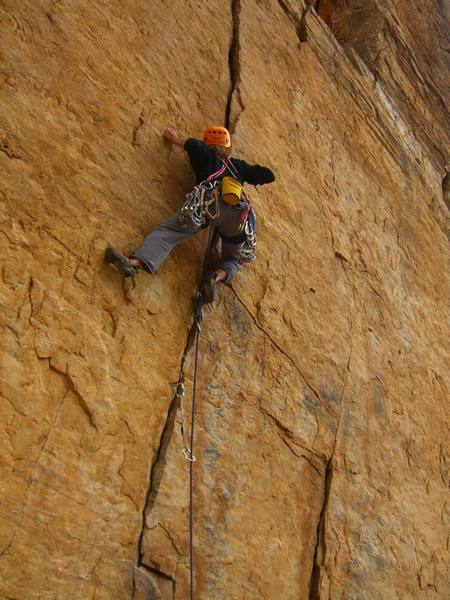 5.9 crack to the right of Community Service. This route finishes with some 5.10 moves above well placed bolts. Name?