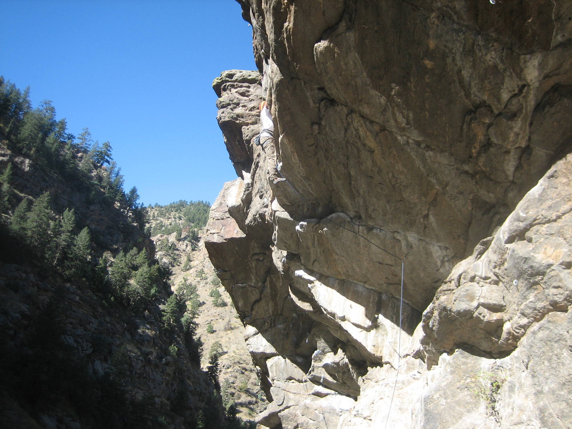 Slowly inching through the first crux over the lip.