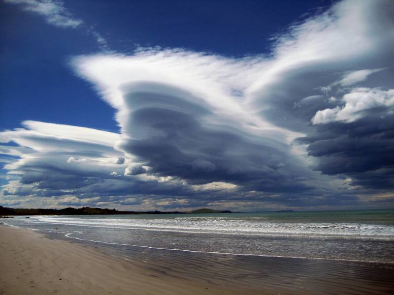 This is the stuff good vacations are made of. White sands, blue-green water, and stunning clouds at Moereki Beach on the east coast of the South Island, just north of Dunedin.