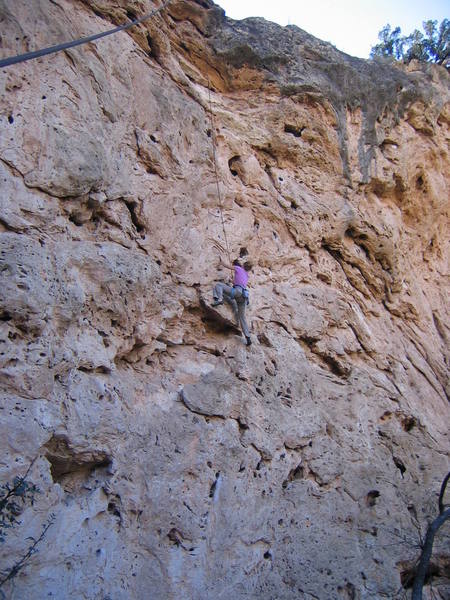 High on the featured travertine of the Rosebud Wall. The rock is very sharp, with plentiful holds. The rock on Big Horn is much more monolithic.