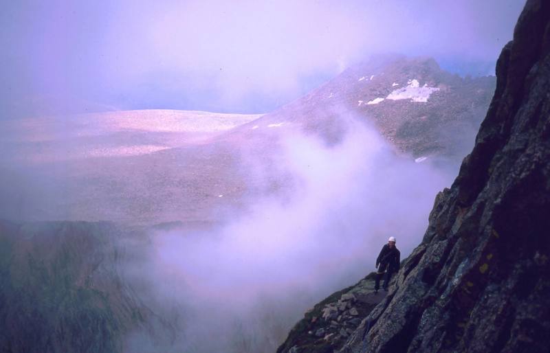 Clouds gather... An odd rush of clouds create odd light on the Diamond. Mark Speiker on Table Ledge.
<br>
<br>
Photo by Tony Bubb, 1997.