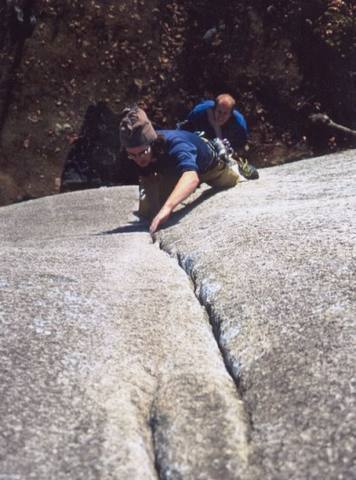 Nearing the switching cracks crux on Crime of the Century. Photo of Connor Reynolds by Matthew Buckle, used with permission.