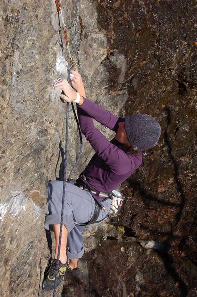 Kayte clipping the bolt after the traverse and before the crux, at the rest jug.