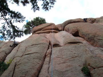 Photo of Aaron atop Reefer Madness, Turkey Perch, South Platte. The double cracks to the left of the rope.