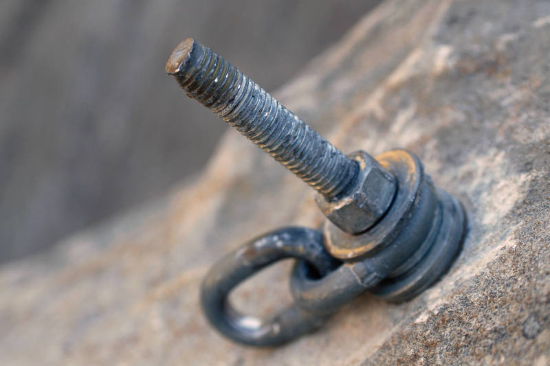 With only moderate resistance, the bolt withdrew farther and farther from the hole. Eventually, the bolt withdrew enough that the expansion clip at the bottom of the bolt slipped over the end of the expansion cone and the bolt slid out of the hole.