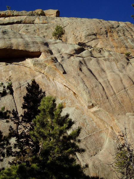 Crescent Arch and some interesting rock to the right. Strategic Arms 11d cuts right through the roof near the top of the photo. You can walk down the ledge below the upper wall with two short bits of easy 5th class.