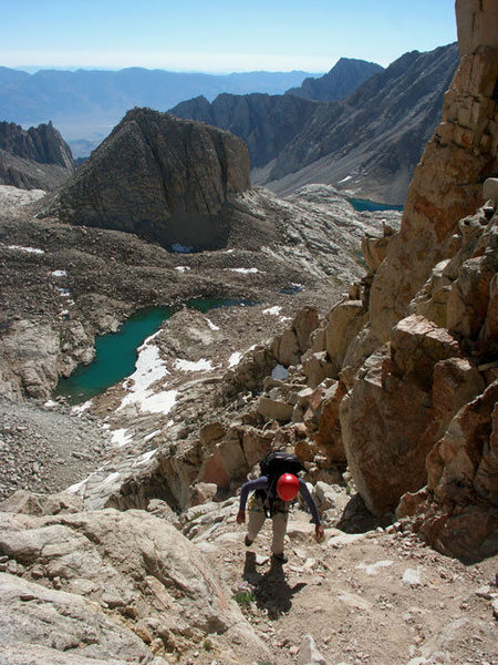 Etsuko is negotiating sandy ledges and gullies low on the East Buttress of Mt. Muir. Wotan's Throne is in the background - July 24, 2004