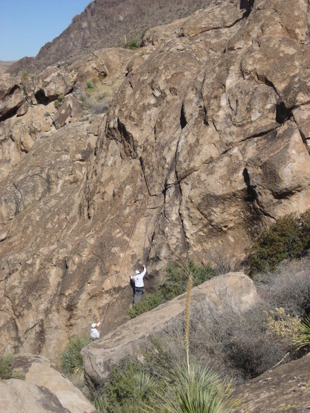 A climber top-roping the face just to the left of the crack. This face was highly friable, and is not recommended.