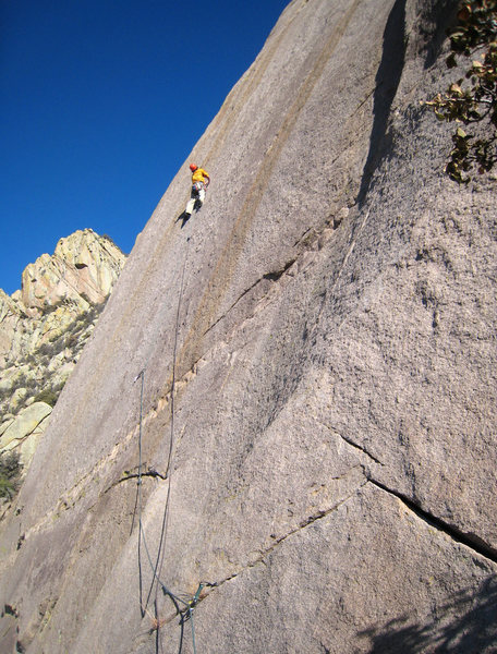 Enjoying a brief moment of relief after clipping the third of four bolts on the stellar 5.10 friction pitch on Tooth Or Consequences.