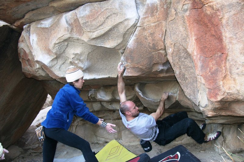 Mike midway through the crux sequence of Scorpion Traverse, V4